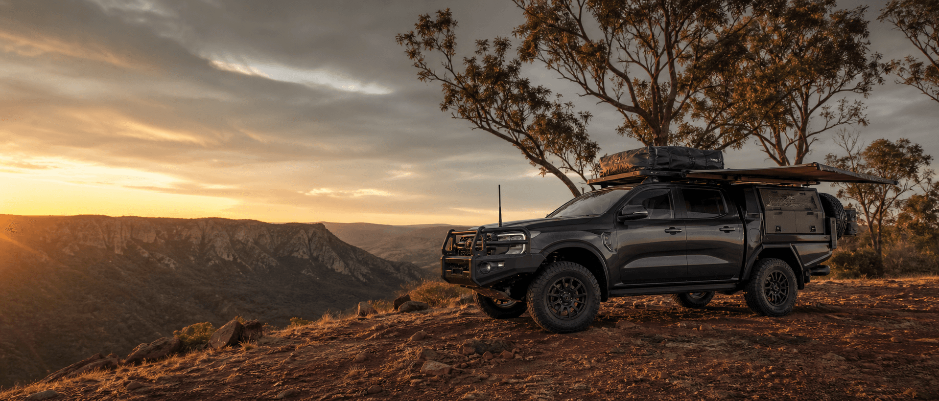 Touring-equipped 4WD overlooking the Australian outback